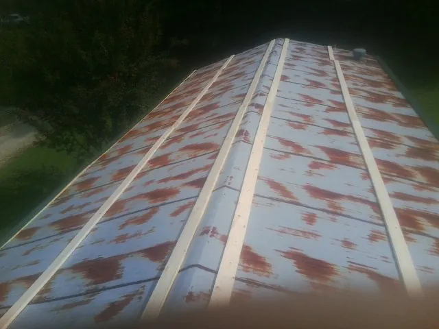 Rusted metal roof panels with new wood purlins before replacement — Storm Damage Roof Repair in Morgan by Roofing Brothers